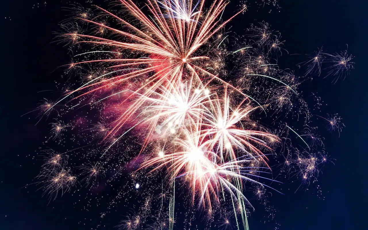 Fireworks display bright explosions of color in a dark sky